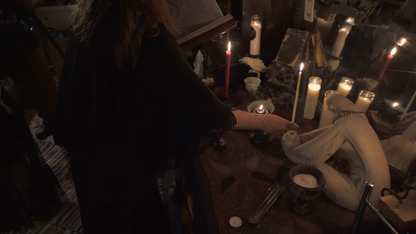 Witch performing a powerful spell ritual at a candlelit altar with sacred tools, white taper candles, incense smoke, and a spiritual statue centerpiece. Surrounded by spell jars, a grimoire, and ritual herbs. Captures the energy of real witchcraft in action. Perfect for Etsy listings offering custom spells, spiritual services, candle magick, altar rituals, pagan ceremonies, energy work, and ancestral spellcasting by a professional witch. Real witch coven magic.