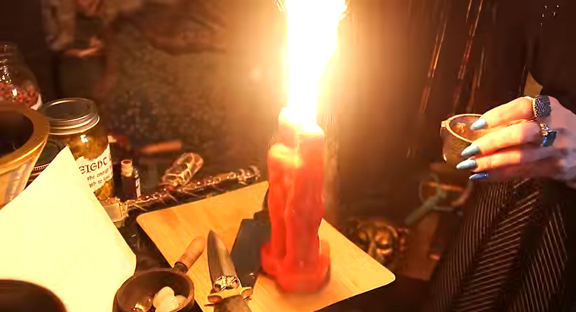 Close-up of an active spellcasting altar with a red couple candle aflame, ritual dagger, crystals, herbs, and a witch’s hand holding a cauldron bowl. Captures a powerful love or binding spell in progress. Ideal for Etsy listings focused on custom spellwork, love spells, heartbreak, ex lover, hex, curse, binding, soulmate, twin flame, couple rituals, powerful witchcraft, candle magick, spiritual energy work, and handcrafted spell services performed by a professional witch or coven practitioner.